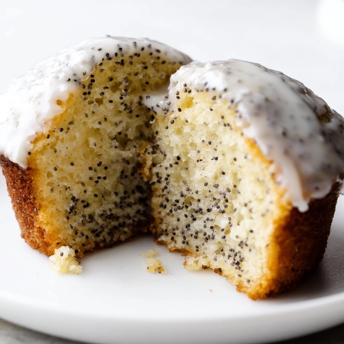 Freshly baked Lemon Poppy Seed Muffins with Lemon Glaze cooling on a wire rack, perfect for a sweet breakfast.