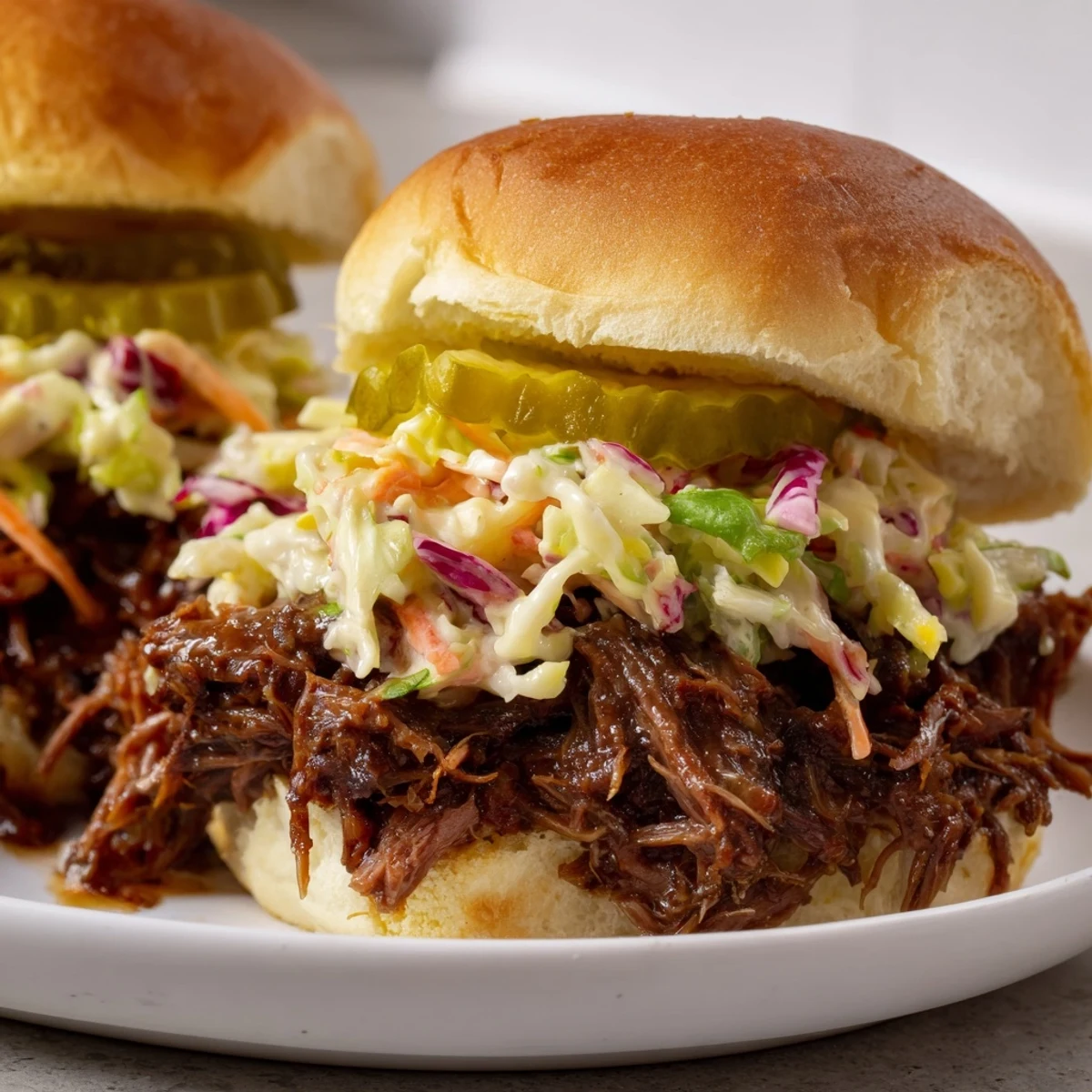 Juicy slow cooked beef brisket sliders with crisp coleslaw and optional pickles, perfect for family meals or BBQs.