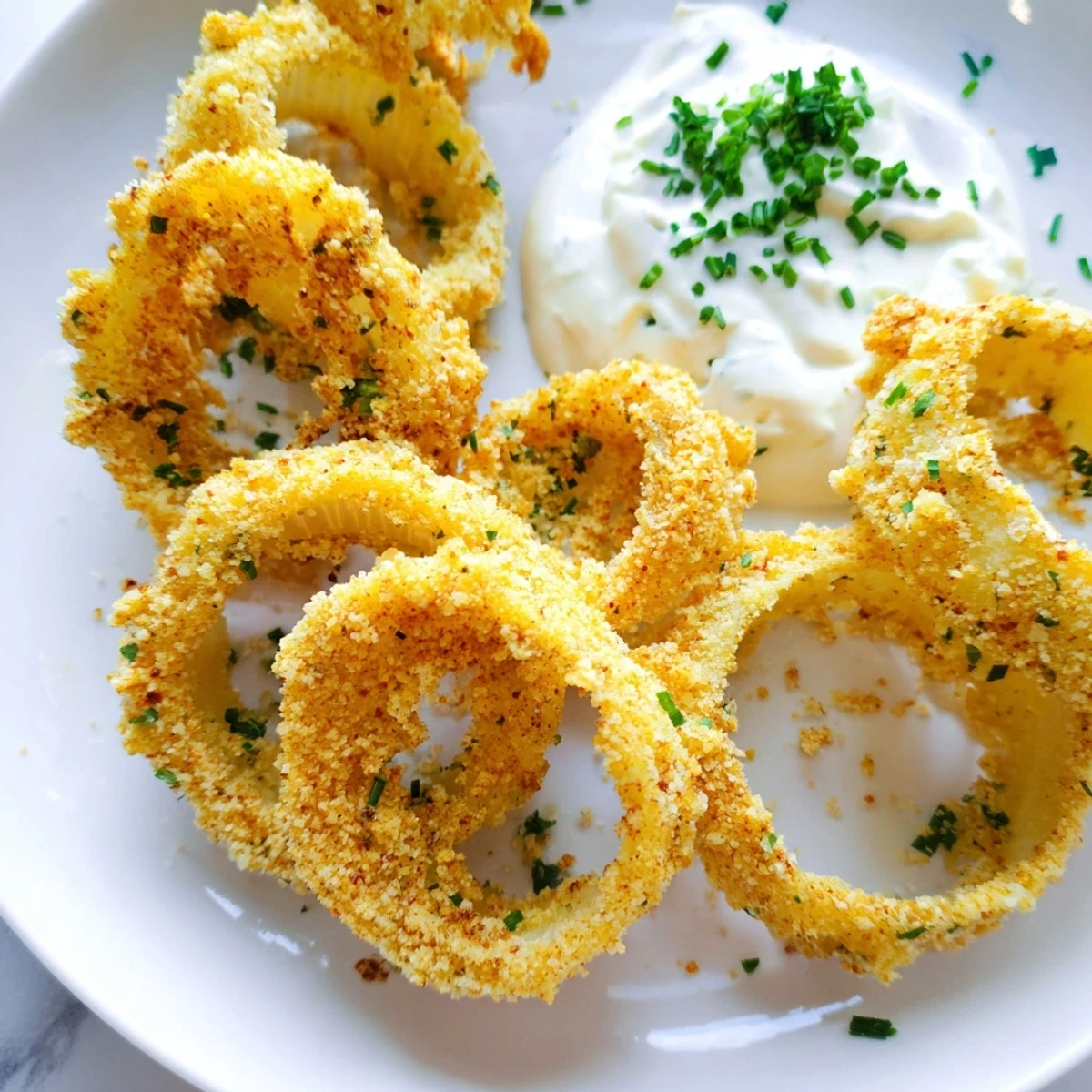 Perfectly golden Crispy Baked Onion Rings with Ranch appetizer, arranged on a platter ready for a family game day gathering.