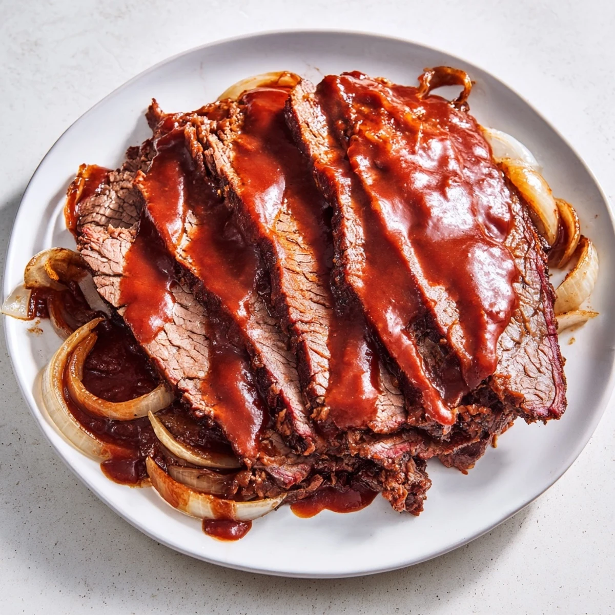Tender Slow Cooker Beef Brisket with BBQ Sauce served on a plate with coleslaw and roasted potatoes.