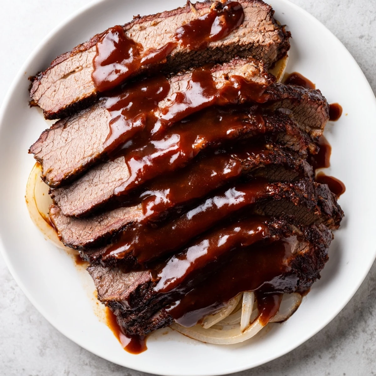 Close-up of Slow Cooker Beef Brisket with BBQ Sauce showing juicy meat fibers and glossy barbecue glaze.