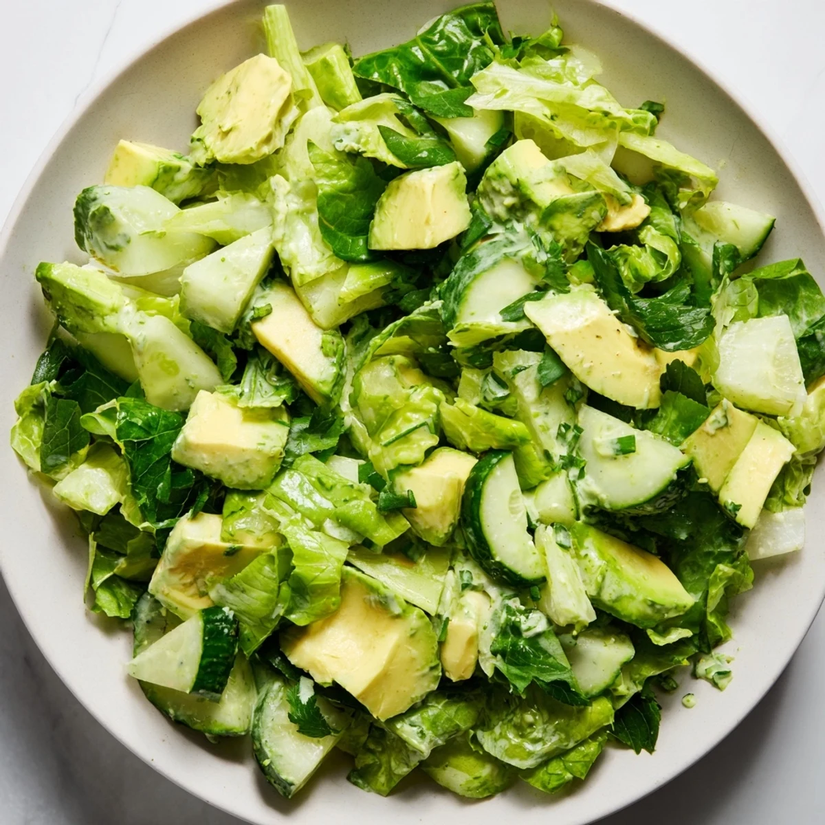 A close-up of the Green Goddess Salad with Avocado and Cucumber showing creamy diced avocado and crisp cucumber in a bowl.  