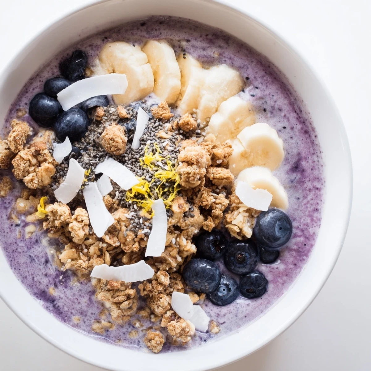 Healthy Lemon Blueberry Smoothie Bowl with fresh fruit toppings and granola, perfect for a gluten-free vegetarian breakfast or refreshing snack.