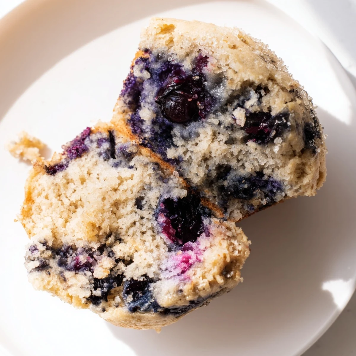 Freshly baked Blueberry Protein Muffins with Greek Yogurt rise tall with golden tops, ideal for an easy American breakfast or snack.