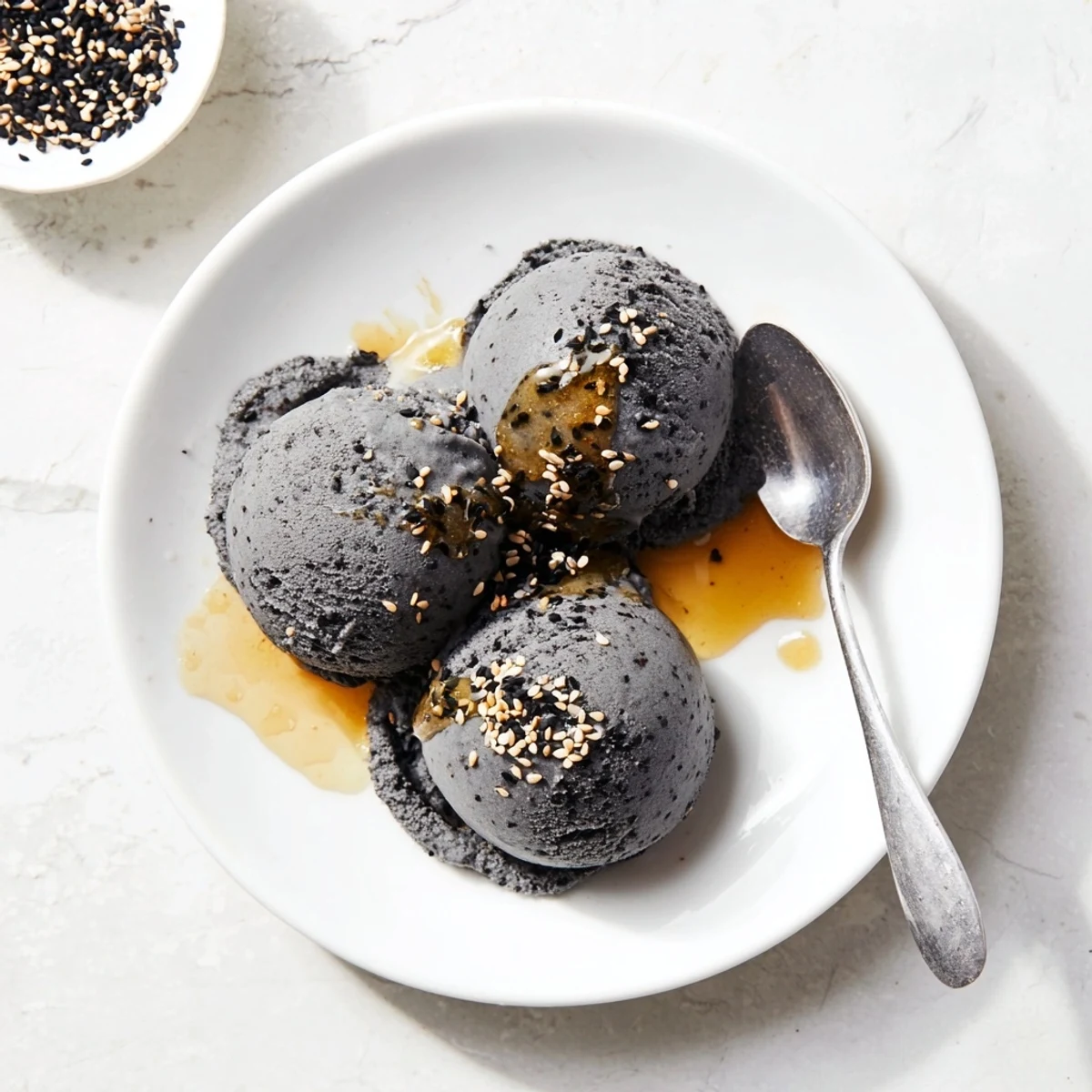 Rich, nutty Toasted Black Sesame Ice Cream in a cone, ready to enjoy on a warm afternoon.