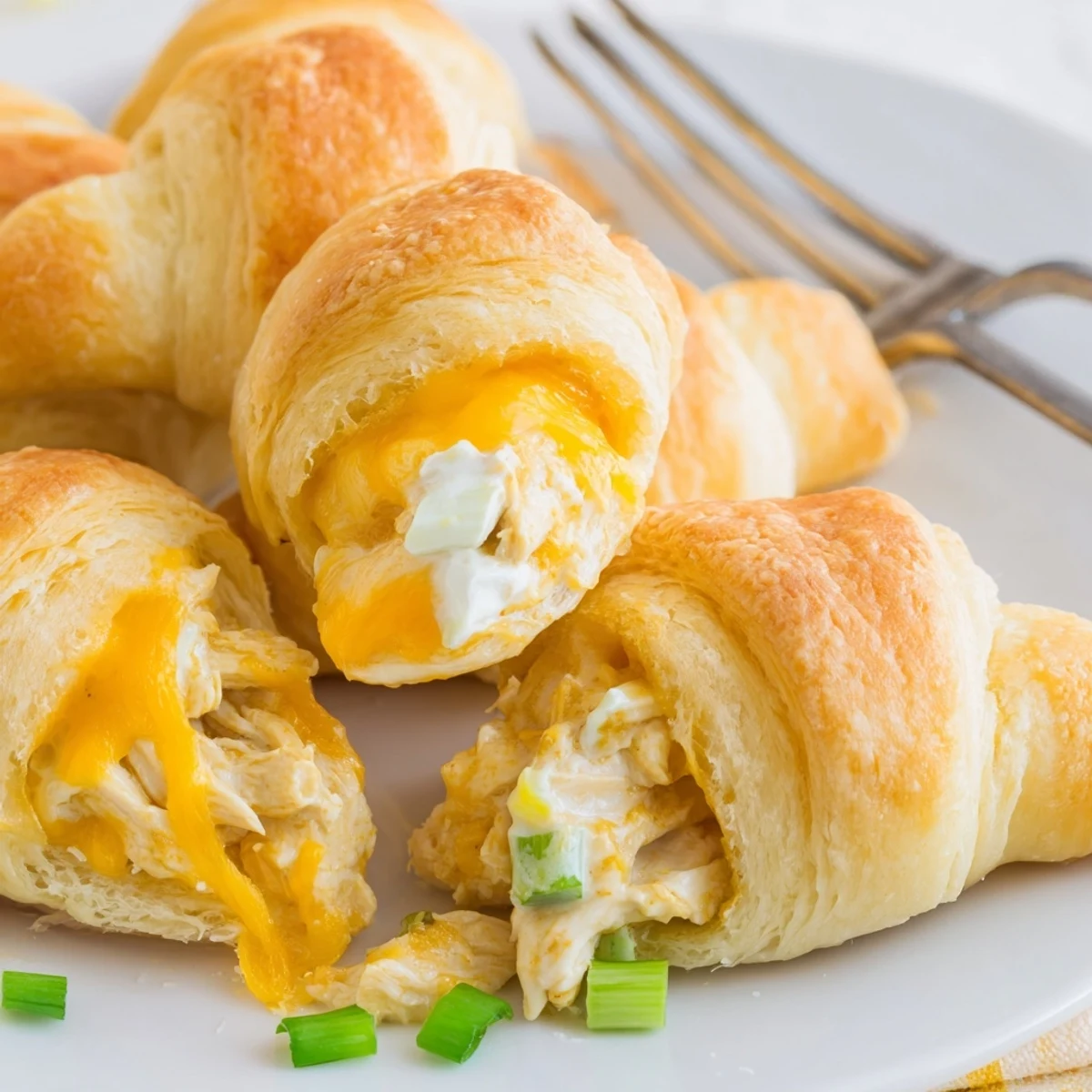 Family-friendly cheesy chicken crescent bake topped with melted mozzarella and green onions