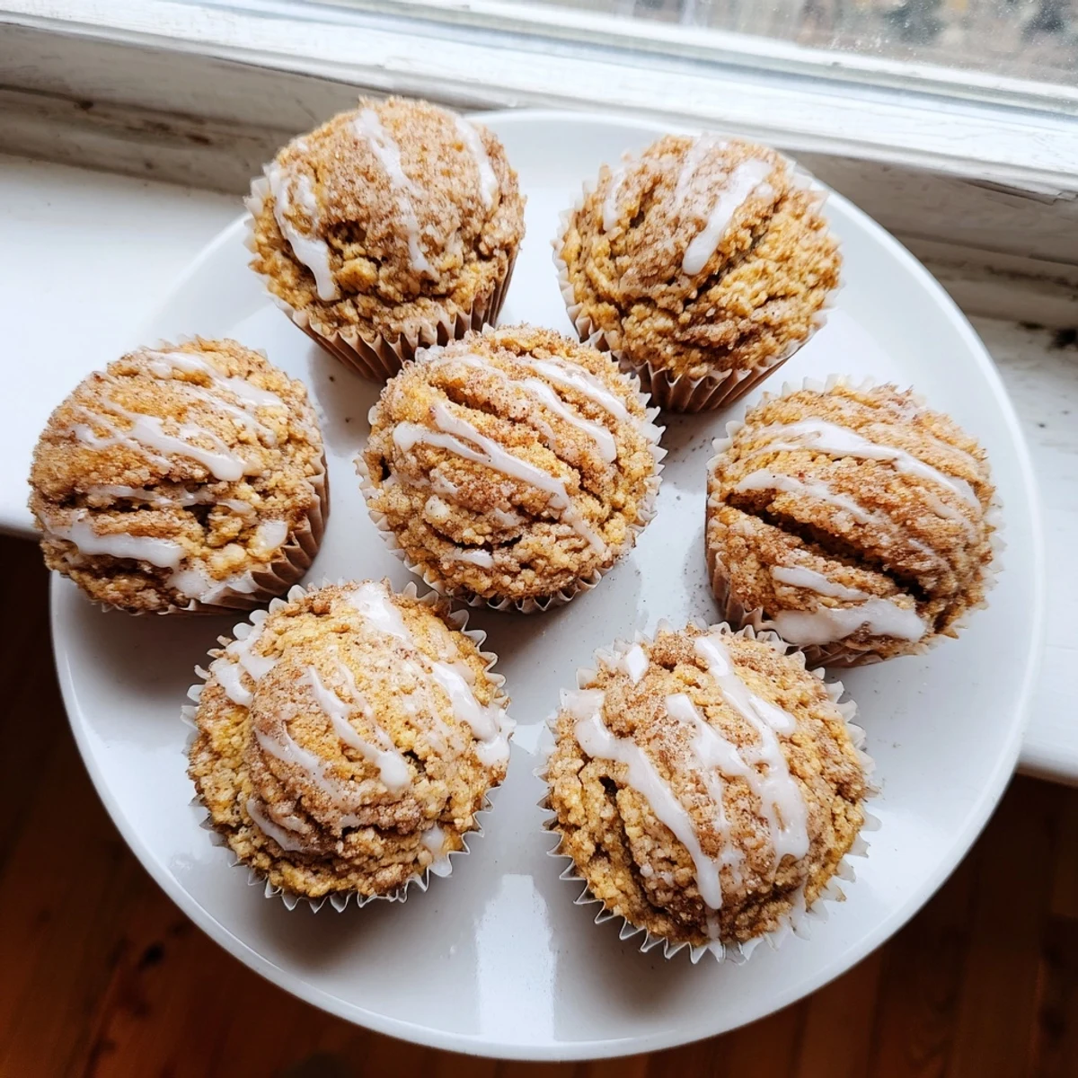 Fluffy high-protein breakfast muffins with spiraled cinnamon sugar layers baked in a lined muffin tin