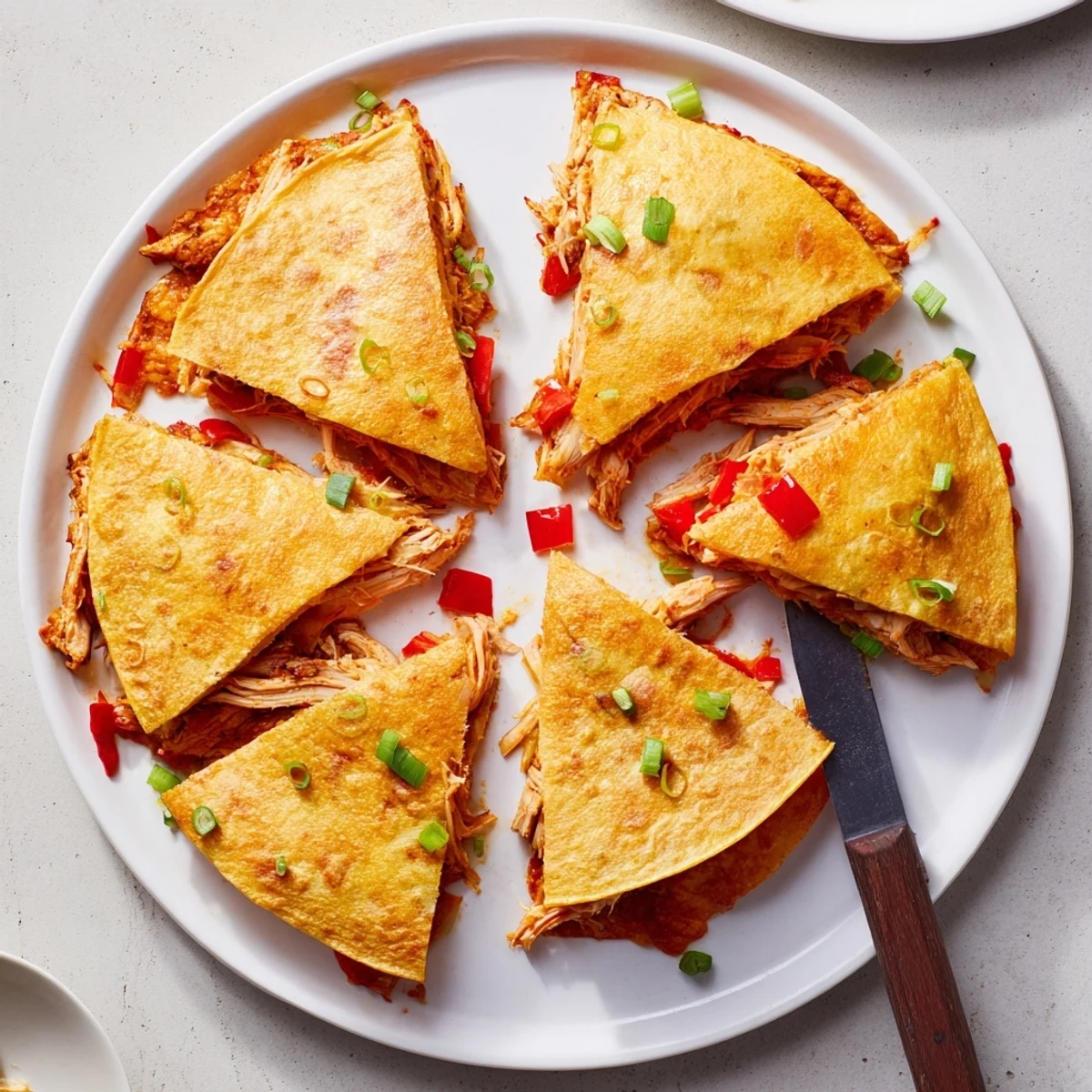 Crispy oven-baked quesadillas stuffed with seasoned shredded chicken and gooey Mexican cheese