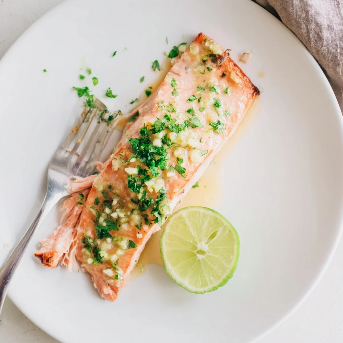 Oven-roasted honey lime garlic butter baked salmon glazed with tangy citrus sauce and caramelized edges