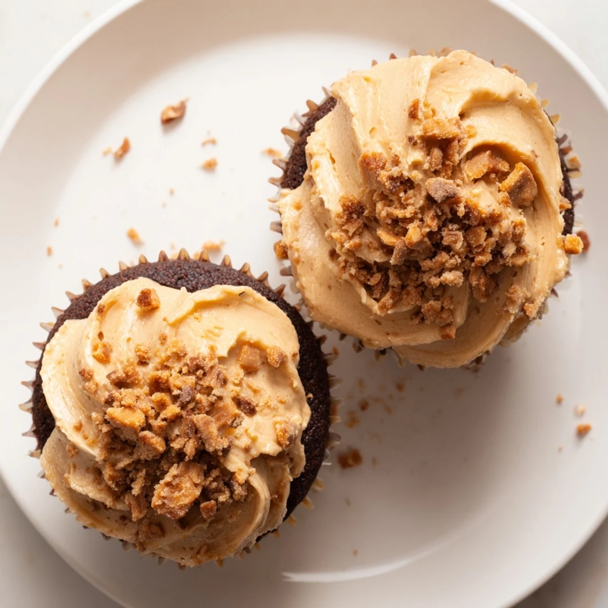 Rich chocolate cupcakes filled with creamy peanut butter and crowned with Butterfinger-infused buttercream frosting
