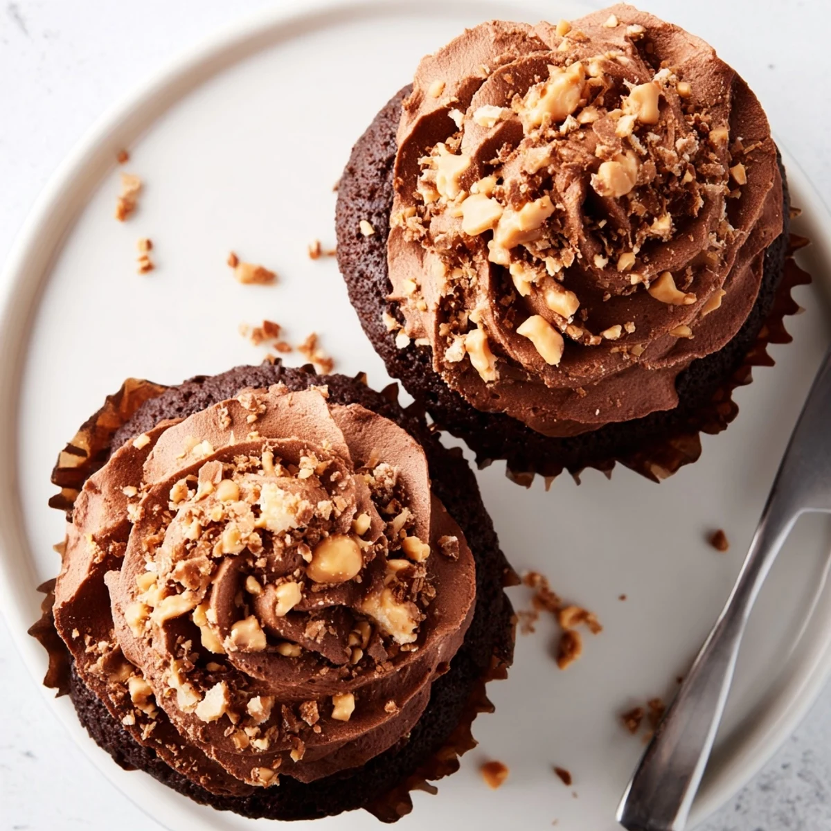 Homemade Butterfinger cupcakes featuring a surprise peanut butter center and crushed candy topping