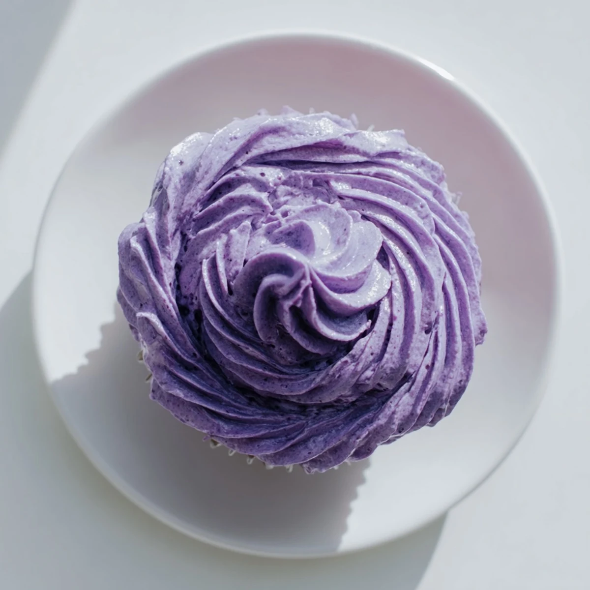 Close-up of moist grape soda cupcakes featuring purple grape buttercream and grape candy decorations