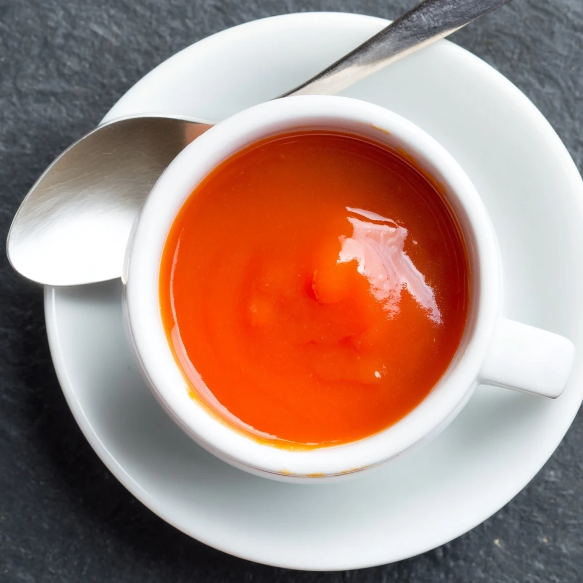 Golden homemade McDonalds sweet and sour sauce in a white ramekin with dipping garnish