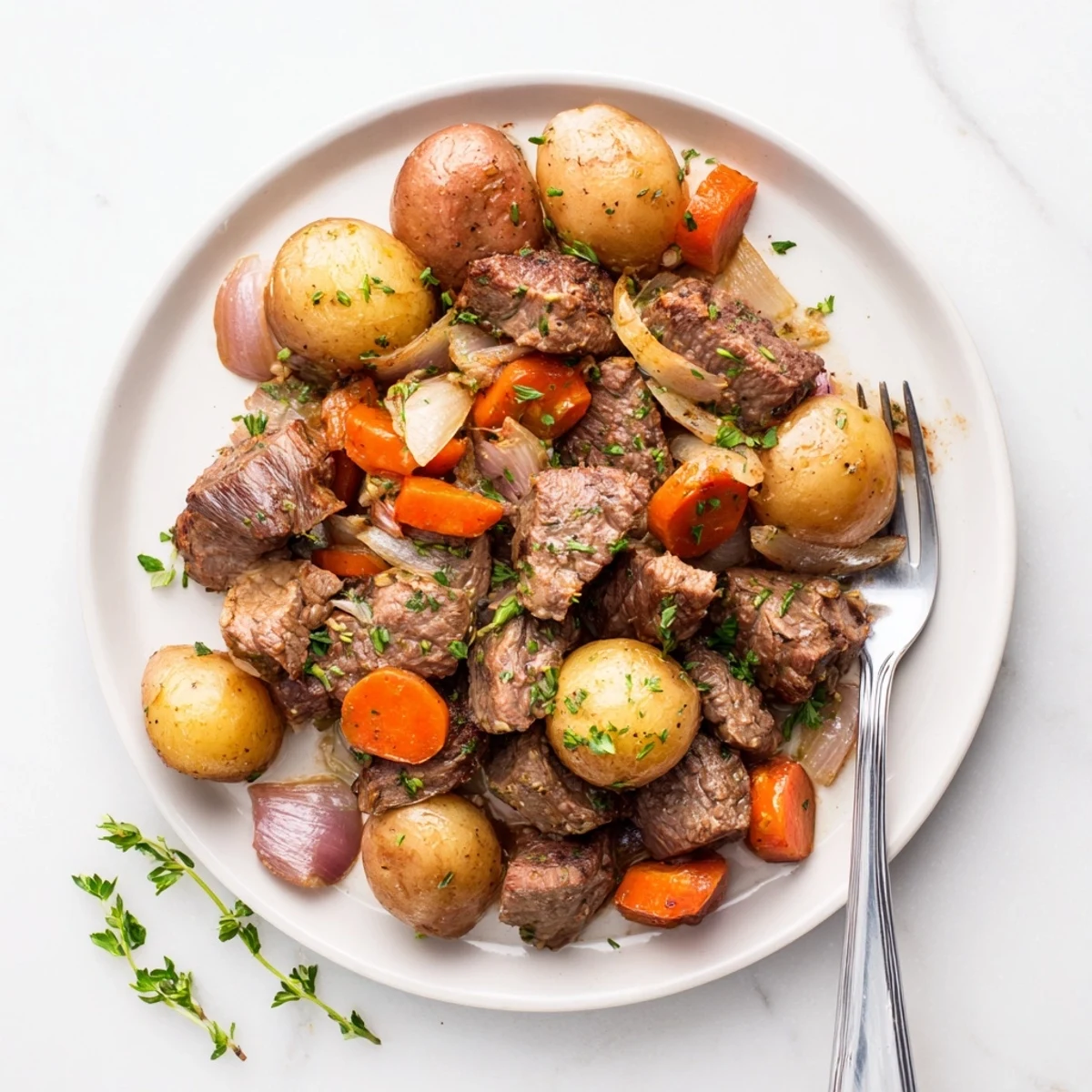 Golden brown seared beef steaks nestled with tender baby potatoes in a rich slow cooker meal
