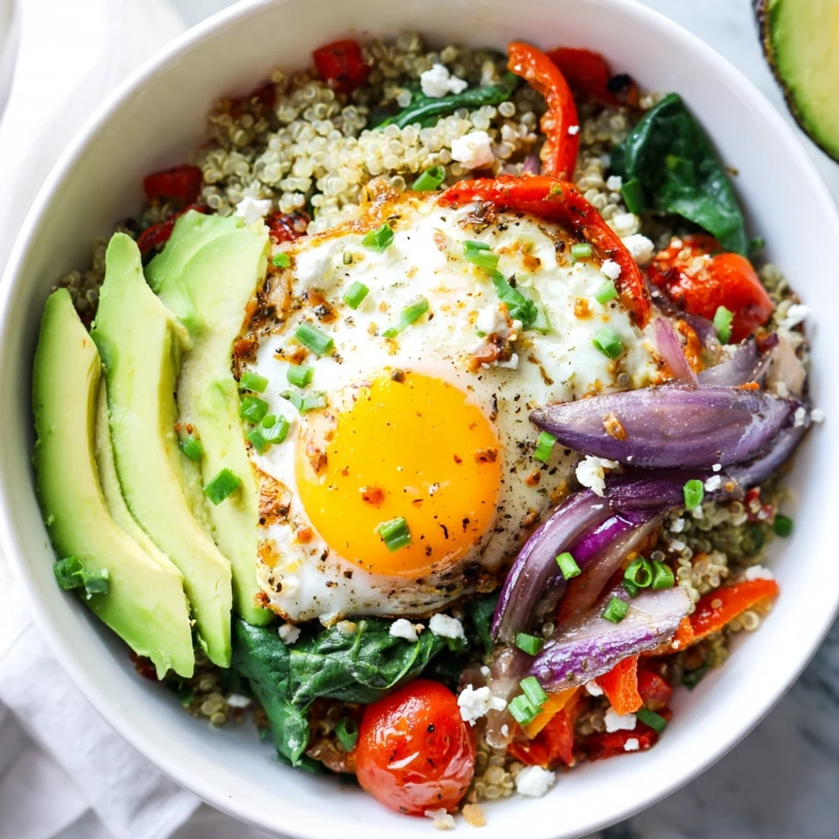 Hearty savory quinoa breakfast bowl featuring fluffy quinoa, wilted spinach, and perfectly cooked egg