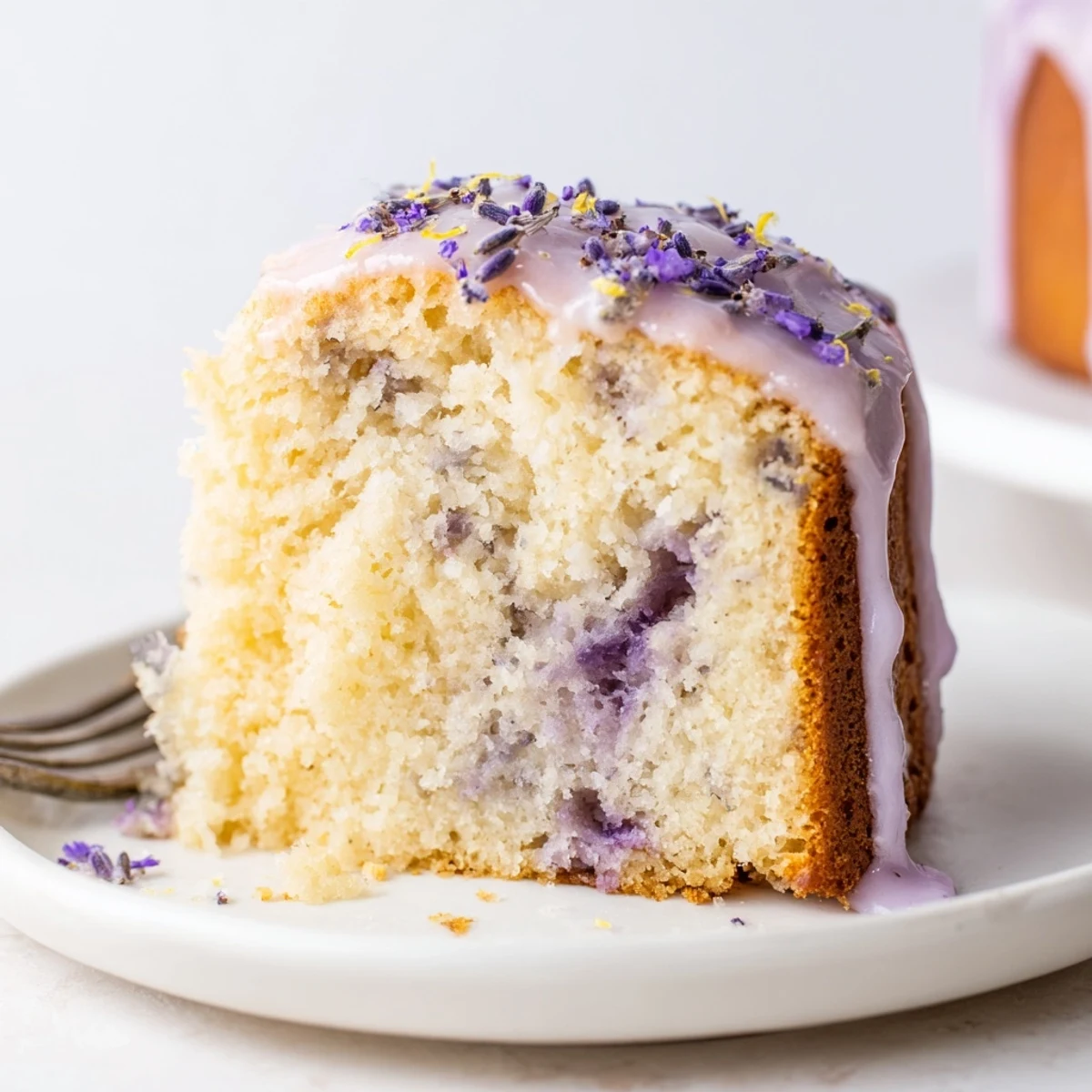 Lavender cake with lemon glaze drizzled over a tender golden crumb