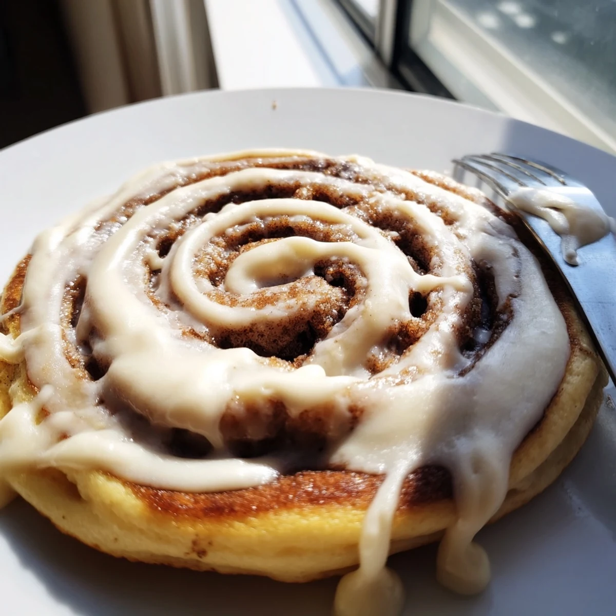 Fluffy pancakes swirled with brown sugar cinnamon filling and topped with sweet icing