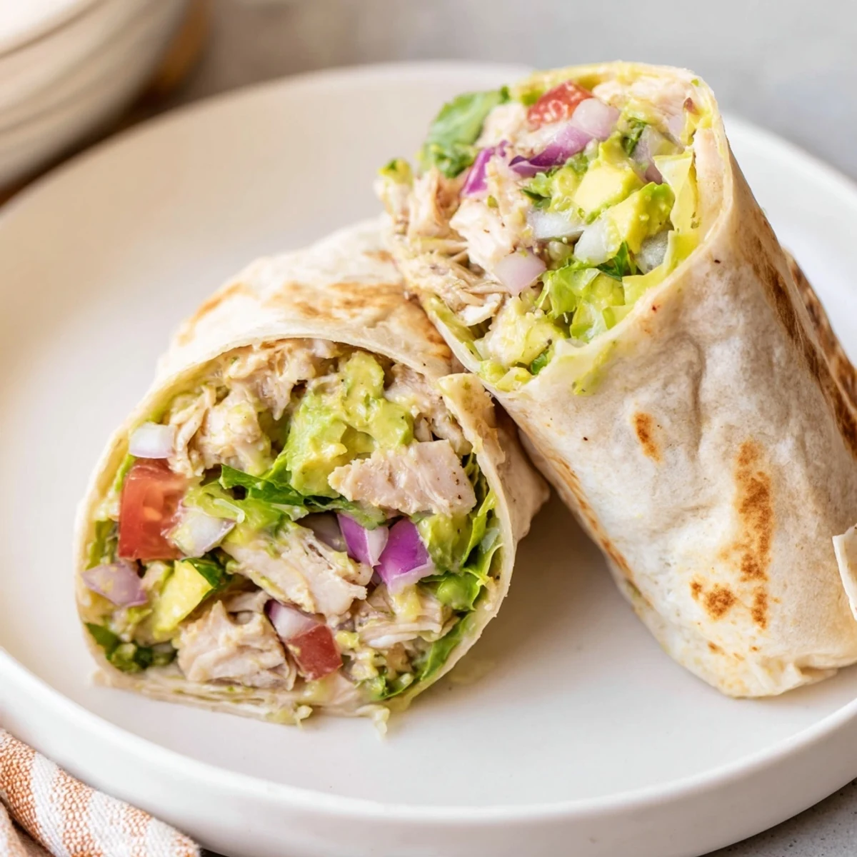 Warm Chicken Avocado Ranch Burritos on skillet, crisp tortilla edges and tangy dressing