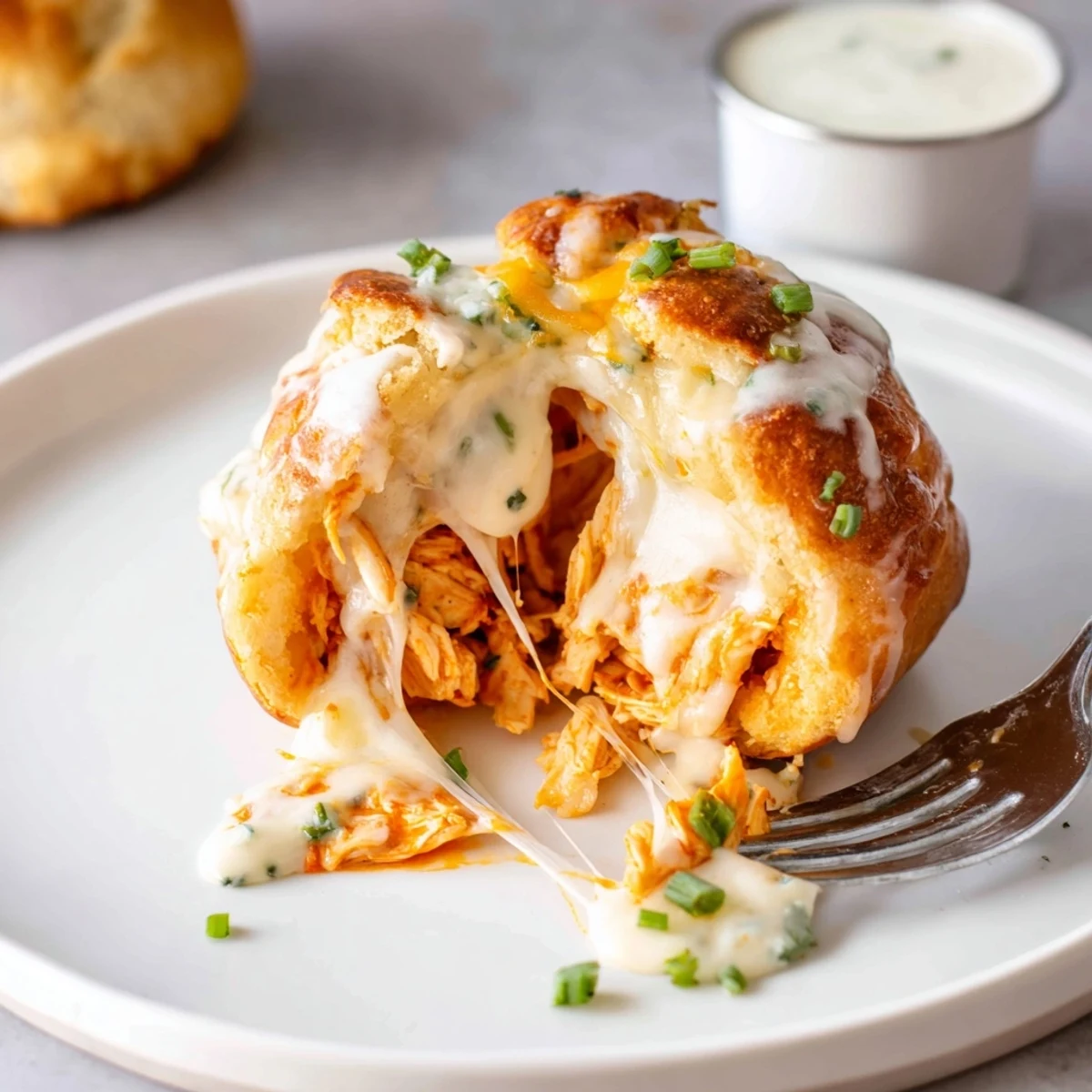 A close-up of Buffalo Chicken Mozzarella Bombs, buttery crust and melty center