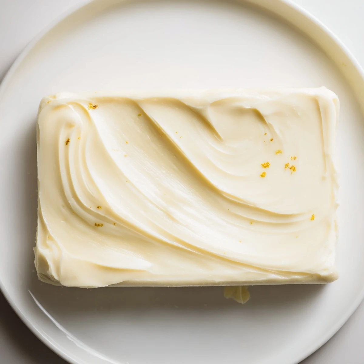 A pat of Vegan Dairy Free Butter softening beside pancakes, buttery aroma