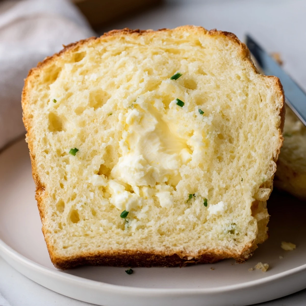 Freshly baked Cottage Cheese Loaf Bread cooling on wire rack, buttery aroma.