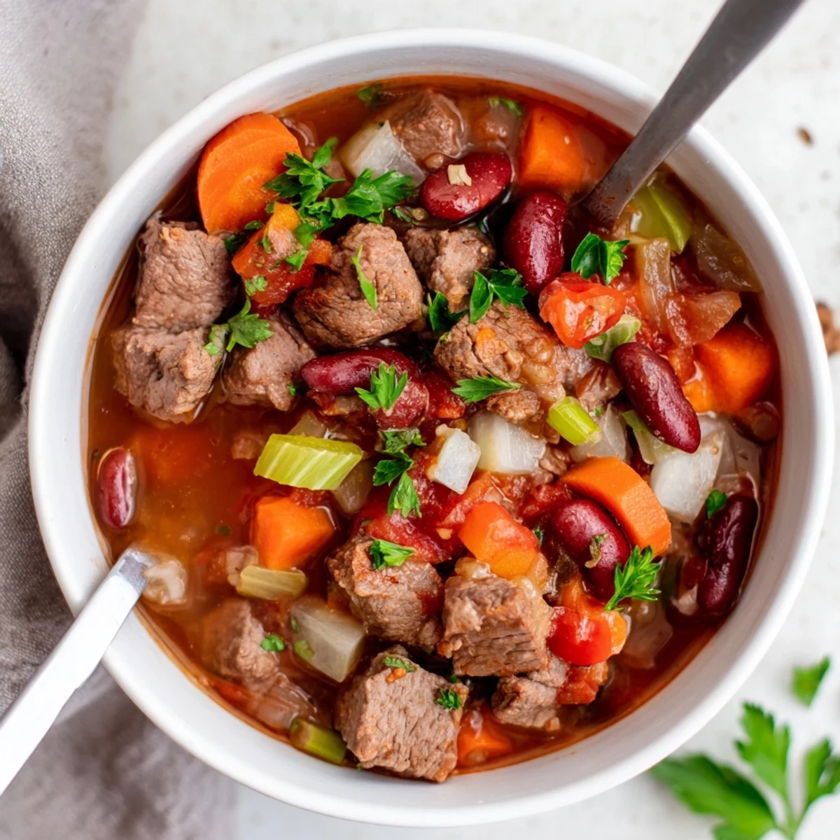 Steaming bowl of savory beef and bean soup delight with tender meat cubes and colorful vegetables