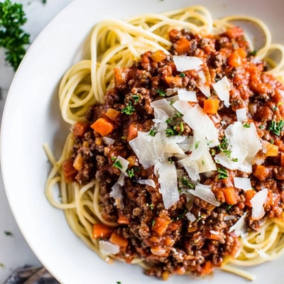Freshly cooked Beef Bolognese with Spaghetti is plated with al dente pasta, offering a comforting, classic Italian-inspired meal.
